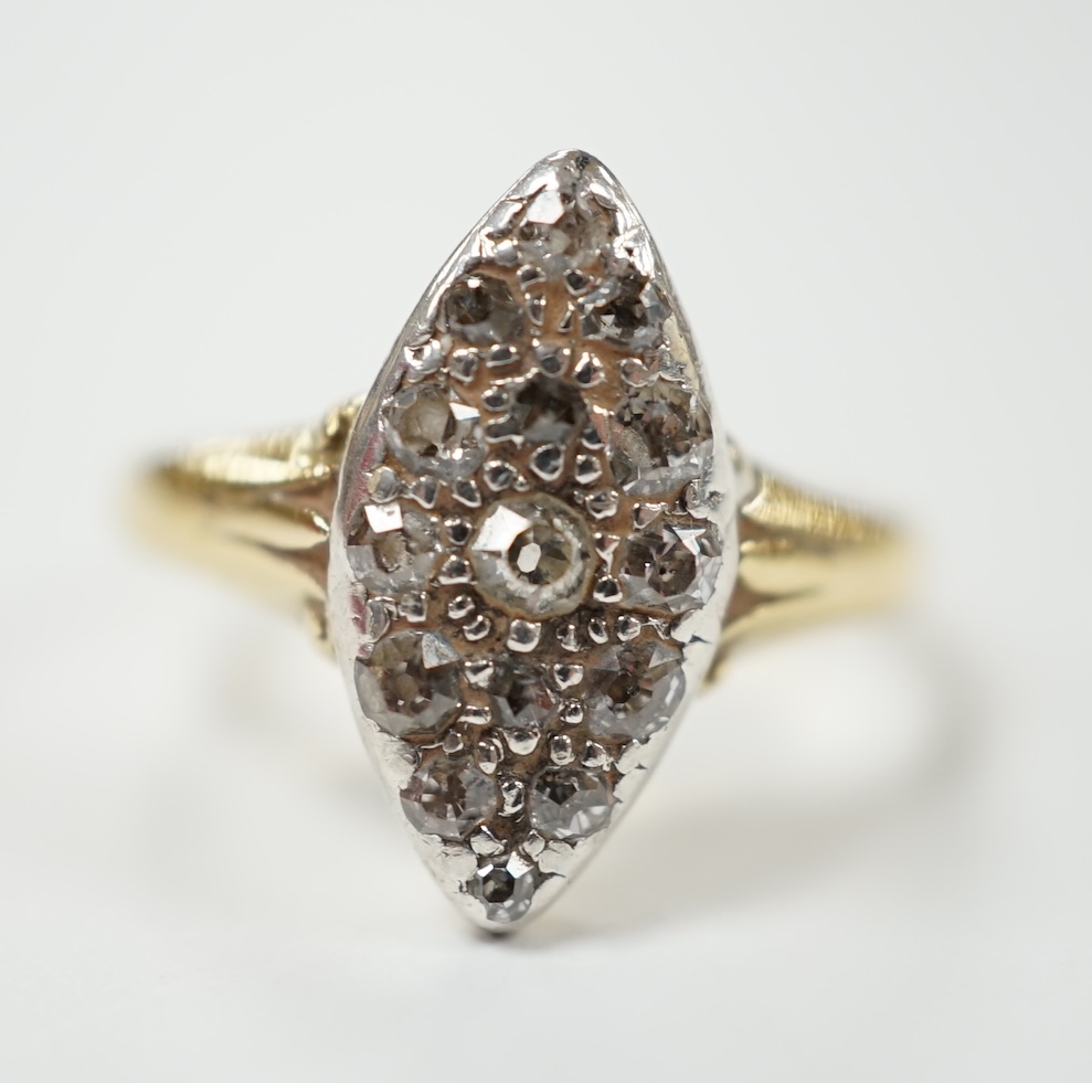 A yellow metal and diamond chip set marquise cluster ring, size K, gross weight 3 grams. Condition - fair